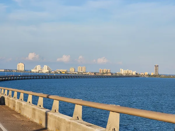The Queen Isabella Causeway crosses blue water toward the South Padre Island skyline.