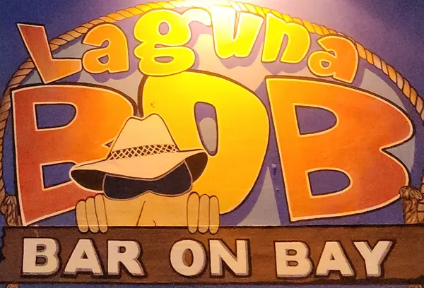 A close view of the Laguna BOB Bar on Bay sign: a cartoon face in a cowboy hat under big orange letters.