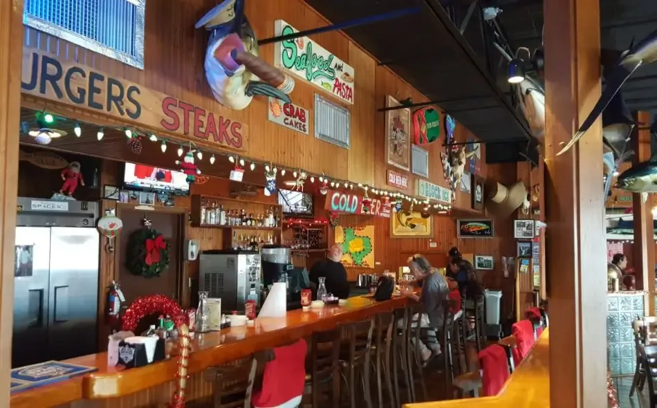 The bar counter with stools, neon signs and holiday decorations