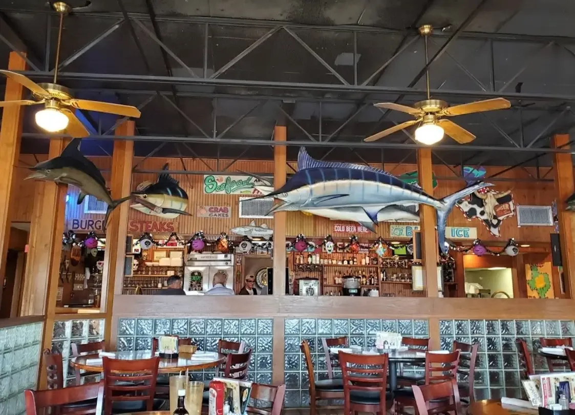 The dining room with mounted marlins and fish on the walls and ceiling fans