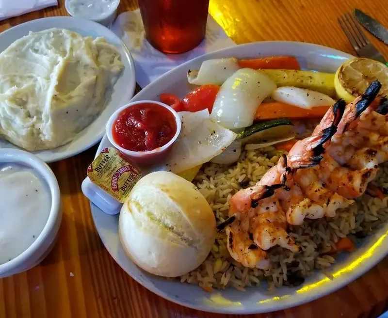 Charbroiled gulf shrimp over rice with grilled zucchini at Blackbeards' Restaurant