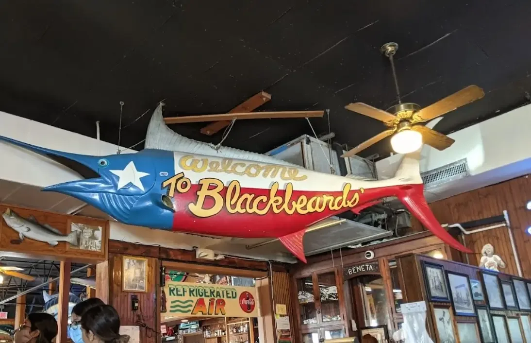 A painted Texas-flag marlin reading "Welcome to Blackbeards'" hung over the dining room