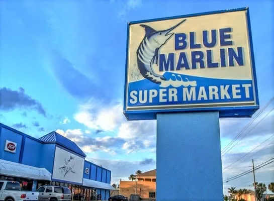 The tall Blue Marlin Super Market sign with a leaping marlin, against a blue sky