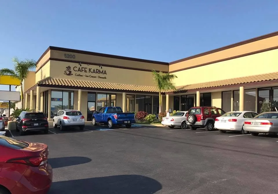 The Cafe Karma storefront at 5200 Padre Blvd, with its "Coffee, Ice Cream, Desserts" sign