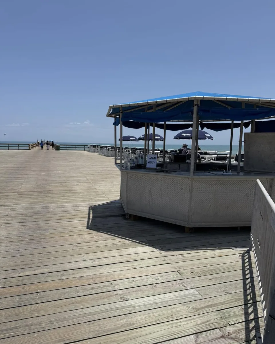The covered bar on Clayton's pier, over the Gulf on a sunny day