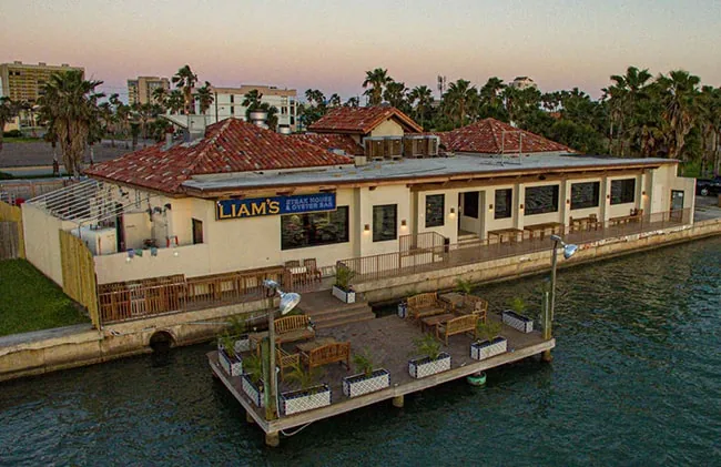 Aerial view of the Liam's Steak House & Oyster Bar building with its dock and outdoor seating on the water
