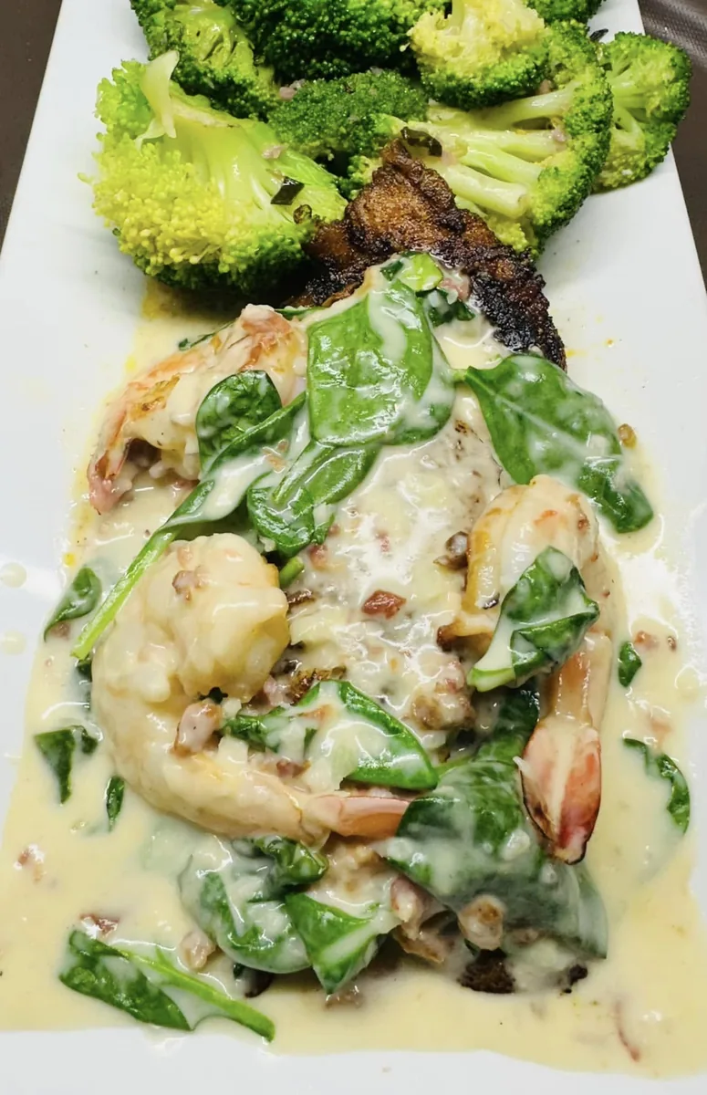 Shrimp and spinach in a creamy bacon sauce over a blackened fillet, with broccoli