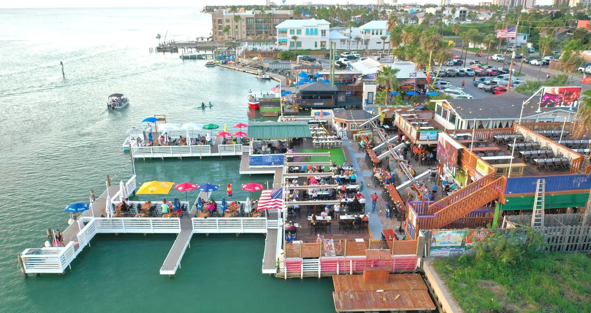 An aerial view of the restaurant, its piers and umbrella-covered decks on the bay