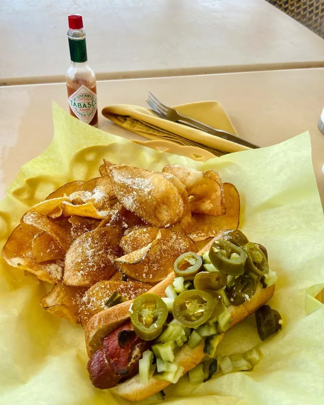 Palms Beach Dog wrapped in bacon with jalapenos and house-made chips at Palms Resort & Cafe on the Beach