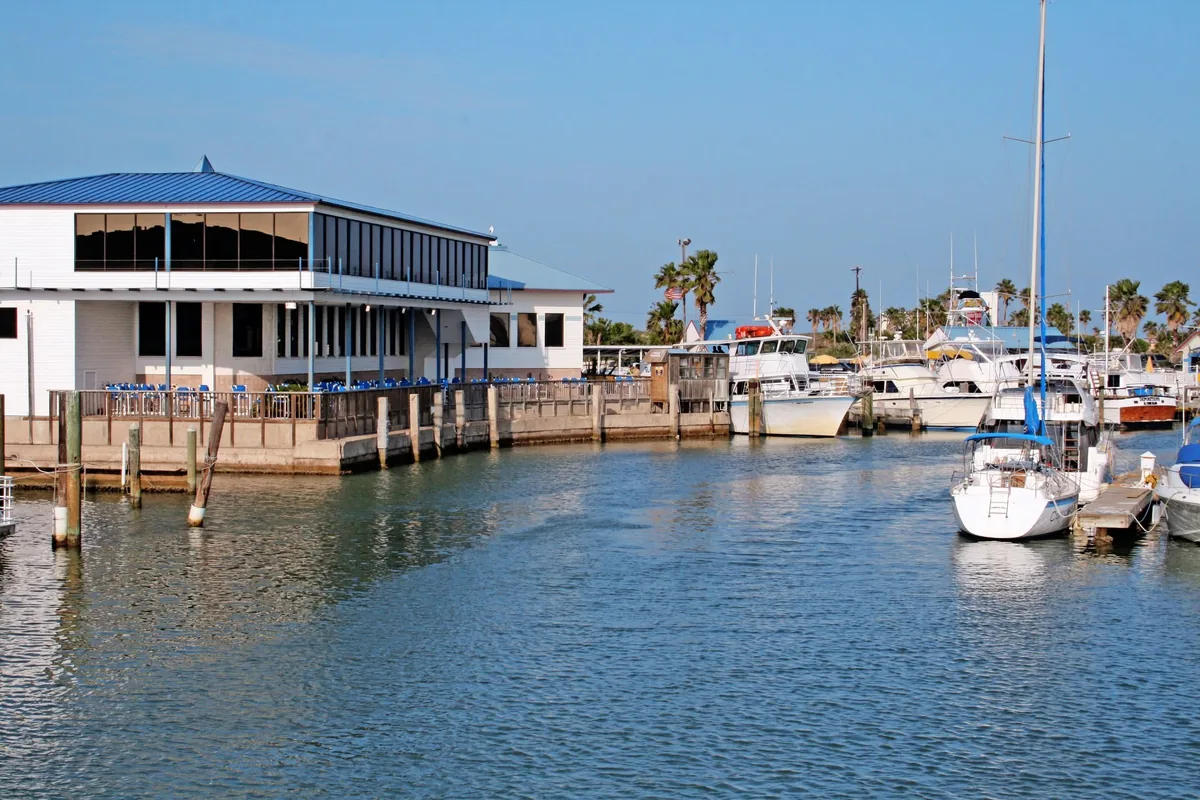 The restaurant's waterfront building on the marina, with boats docked in front